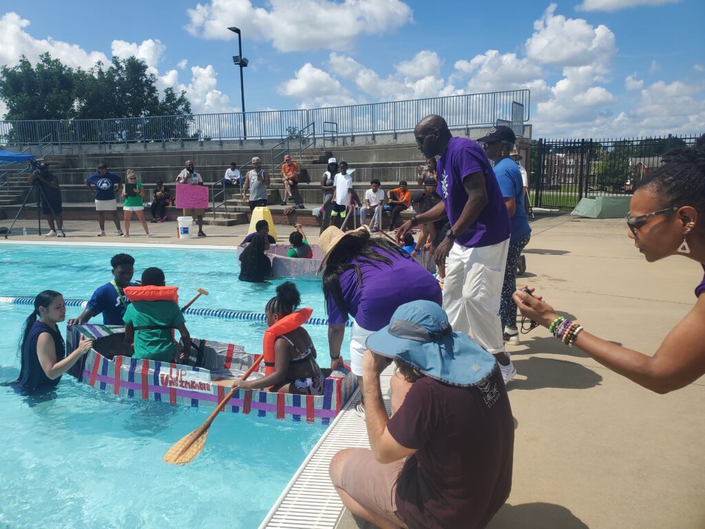 Campers participate in a homemade boat regatta during the Unleashing Potential summer camp.