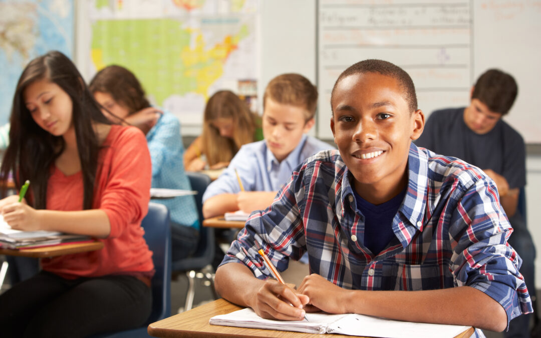 Young black male student participates in college prep program in a classroom setting