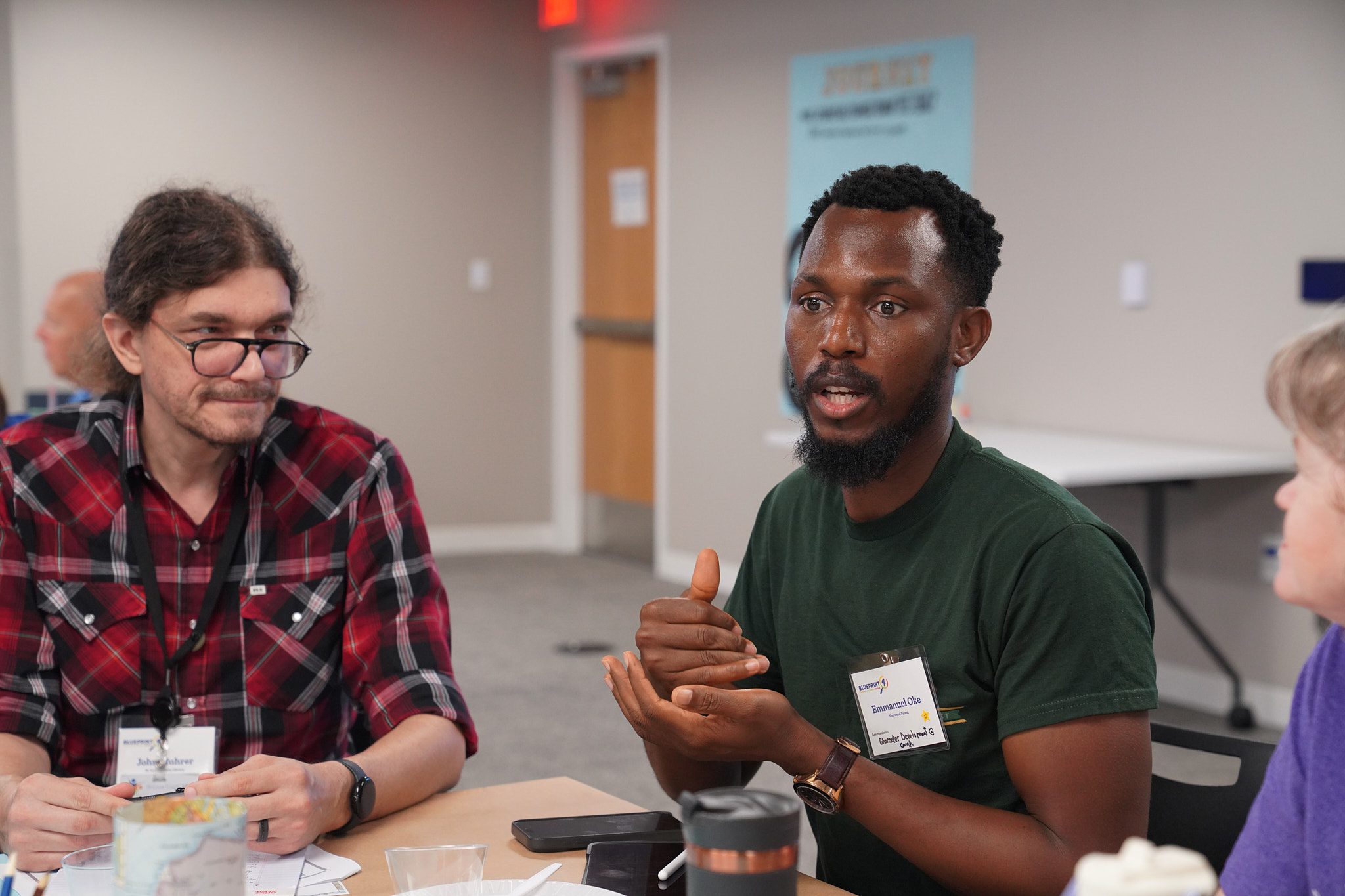 A camp provider speaks to his table during a discussion time.