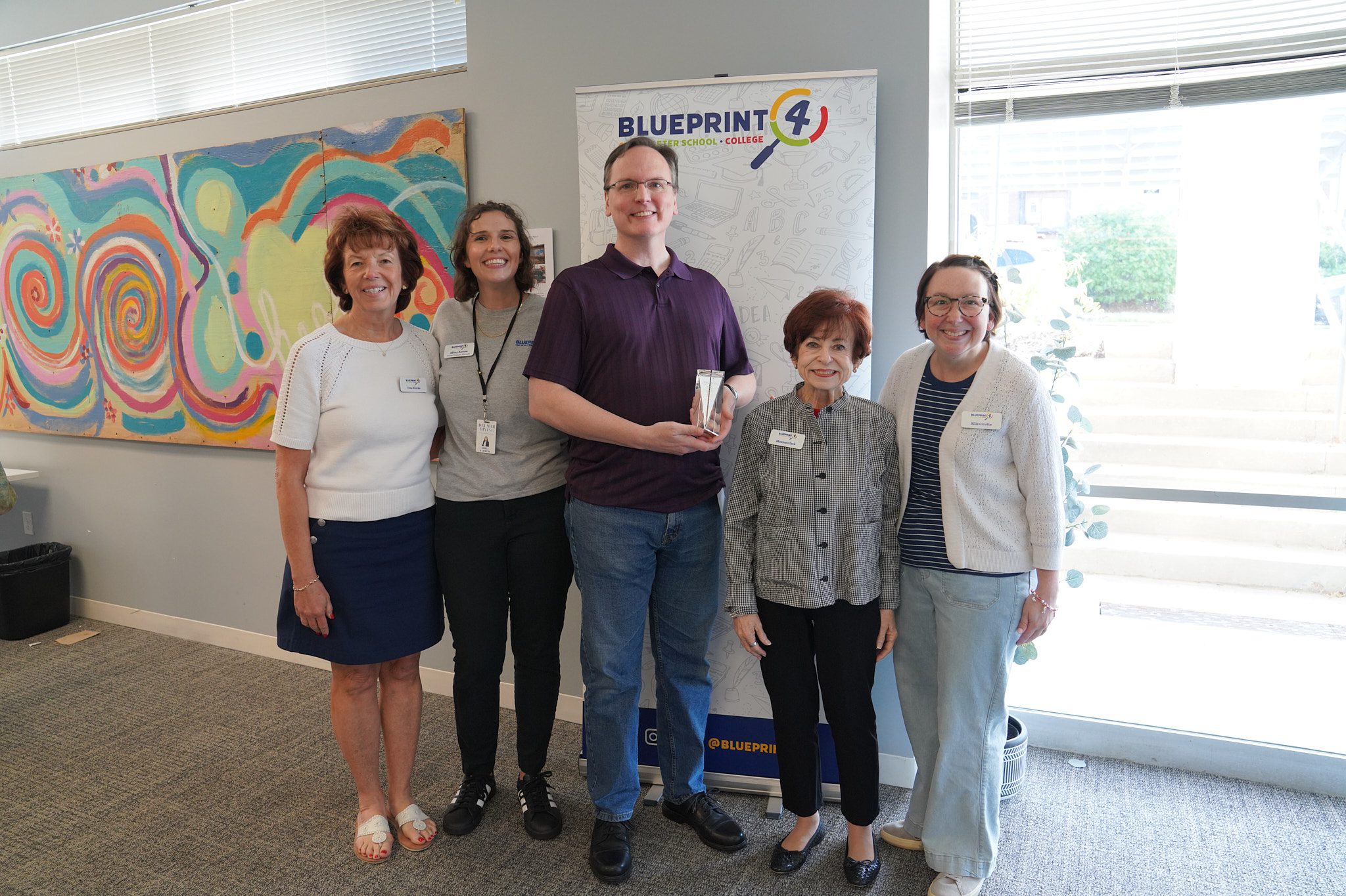 Blueprint4 staff pose with Stephen Decken who has provided IT support to Blueprint4 since it was founded and received an award at the camp summit.